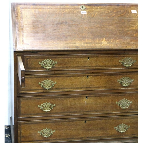 3060 - A George III oak bureau, a fitted interior of drawers and pigeon holes above a four drawer base, 102... 