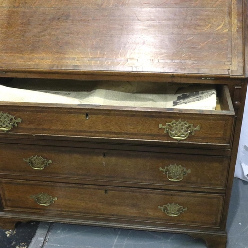 3060 - A George III oak bureau, a fitted interior of drawers and pigeon holes above a four drawer base, 102... 