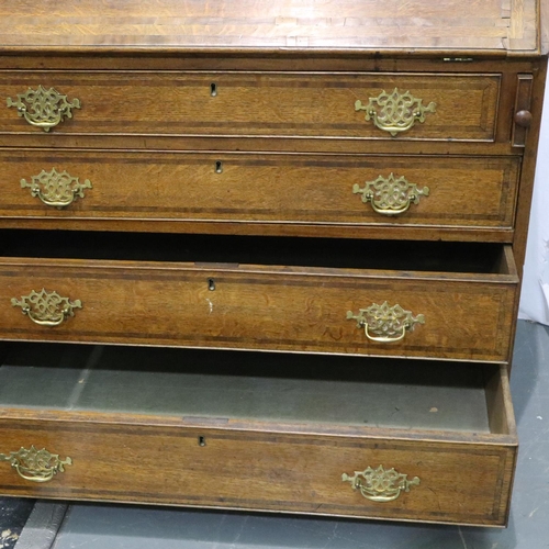 3060 - A George III oak bureau, a fitted interior of drawers and pigeon holes above a four drawer base, 102... 