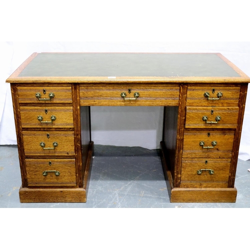 3075 - A Victorian oak twin pedestal desk having two banks of four drawers and green faux leather insert to... 