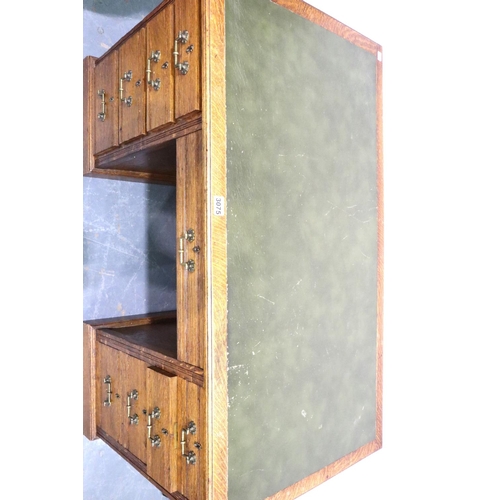 3075 - A Victorian oak twin pedestal desk having two banks of four drawers and green faux leather insert to... 