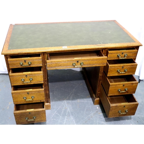 3075 - A Victorian oak twin pedestal desk having two banks of four drawers and green faux leather insert to... 