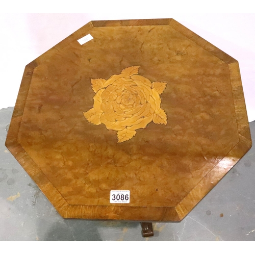 3086 - An early 19th century walnut octagonal table, inlaid with a rose motif and cross banded edge, on bul... 