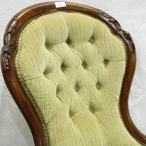 3102 - A Victorian carved walnut parlour chair, with upholstered buttoned back rest and scrolling supports.... 