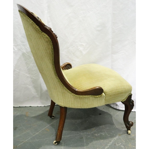 3102 - A Victorian carved walnut parlour chair, with upholstered buttoned back rest and scrolling supports.... 