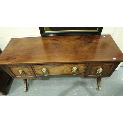 3107 - An early 19th century walnut buffet, having two cupboards flanking a single drawer, lion mask handle... 