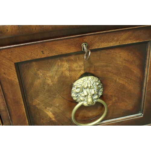 3107 - An early 19th century walnut buffet, having two cupboards flanking a single drawer, lion mask handle... 