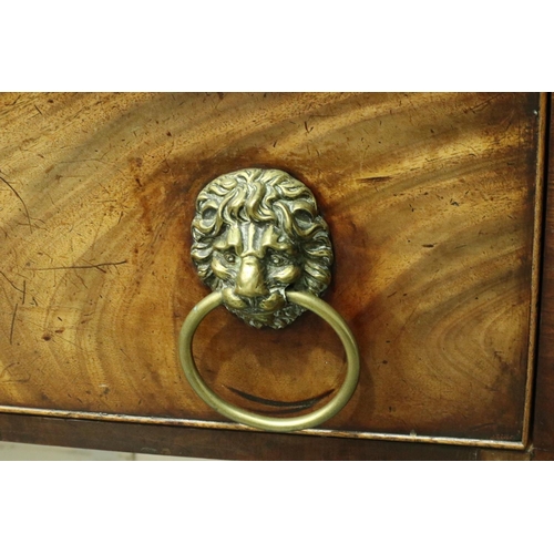 3107 - An early 19th century walnut buffet, having two cupboards flanking a single drawer, lion mask handle... 