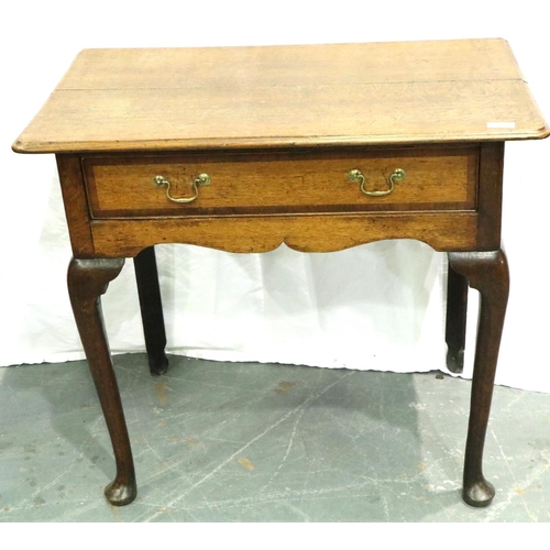 3110 - An early 19th century oak single drawer lowboy, cross banded and with cabriole supports, 80 x 48 x 7... 