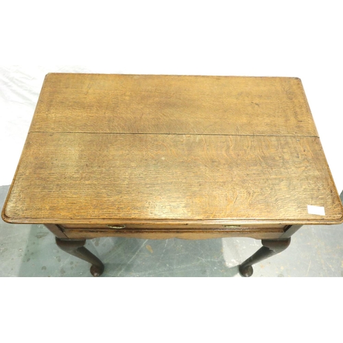 3110 - An early 19th century oak single drawer lowboy, cross banded and with cabriole supports, 80 x 48 x 7... 