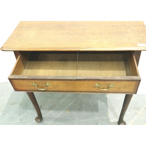 3110 - An early 19th century oak single drawer lowboy, cross banded and with cabriole supports, 80 x 48 x 7... 