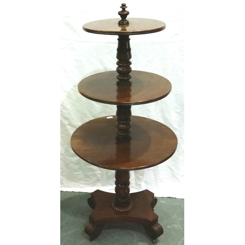 3113 - A 19th century walnut dumbwaiter, circular with three graduated tiers and raised on a quadripartite ... 