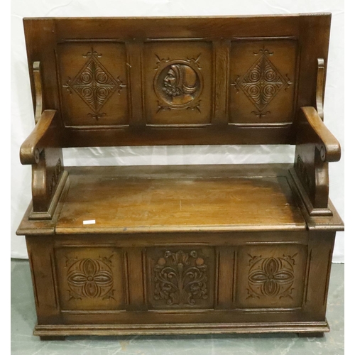 3116 - An early 20th century oak monks bench with tilting top and carved in the Jacobean manner, 106 x 50 x... 