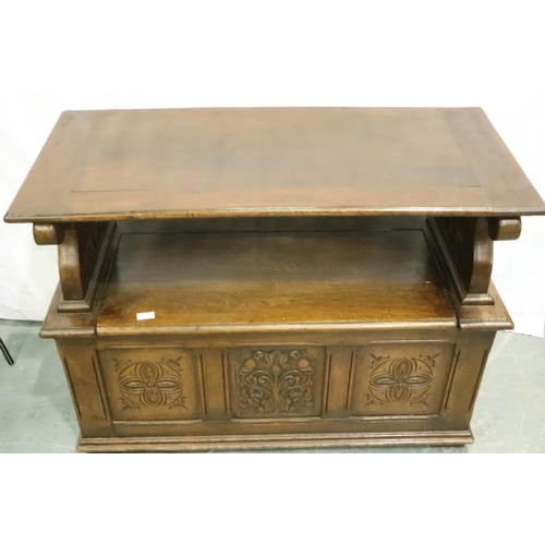 3116 - An early 20th century oak monks bench with tilting top and carved in the Jacobean manner, 106 x 50 x... 