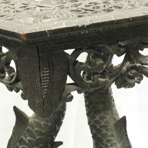 3126 - A 19th century heavily carved Middle-Eastern table, having a hexagona top supported by Mermaid form ... 