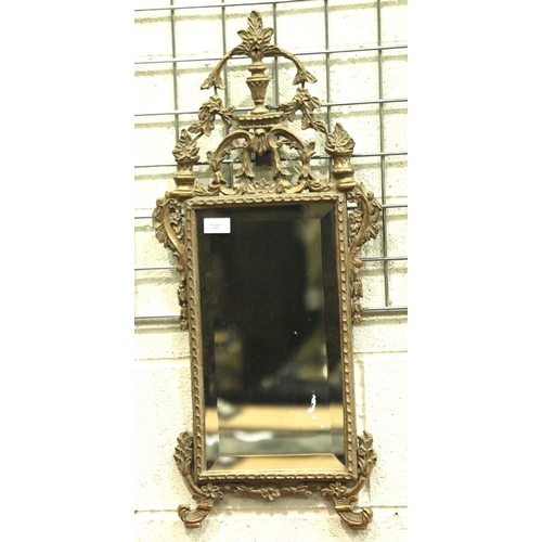 3144 - An early 20th century ormolu framed wall mirror with beveled glass, overall 77 x 34 cm.  Not availab... 