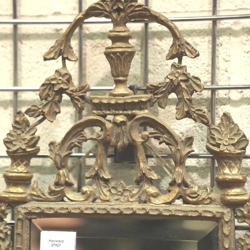 3144 - An early 20th century ormolu framed wall mirror with beveled glass, overall 77 x 34 cm.  Not availab... 