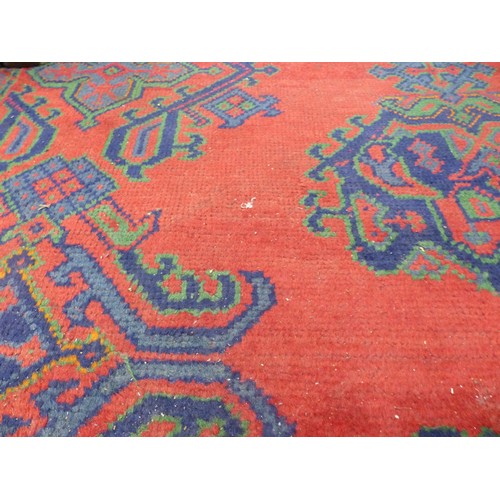 3149 - A 19th century woollen floor rug of strong geometric designs against a red ground, green fringed, 40... 