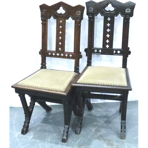 3102 - A pair of Victorian gothic style hall chairs, with pierced back rests and studded upholstered seats,... 