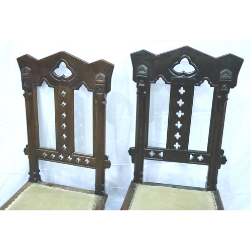 3102 - A pair of Victorian gothic style hall chairs, with pierced back rests and studded upholstered seats,... 