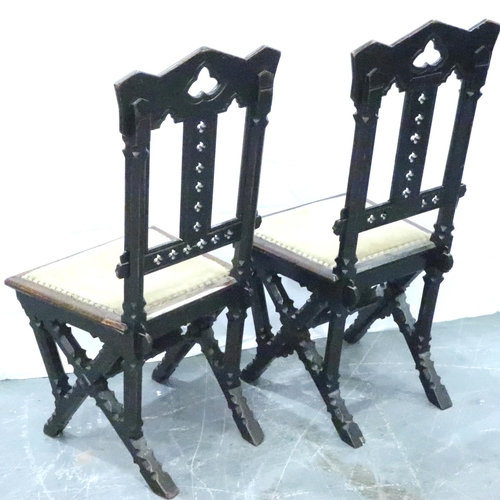 3102 - A pair of Victorian gothic style hall chairs, with pierced back rests and studded upholstered seats,... 