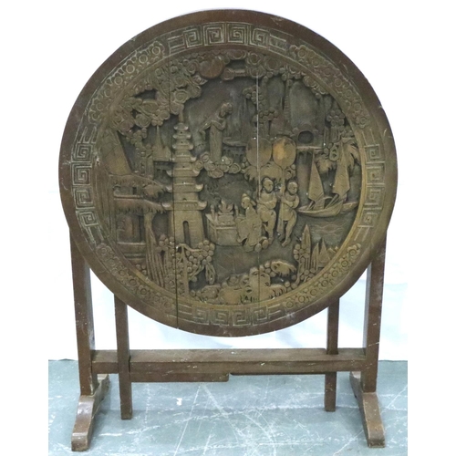 3105 - An early 20th century Chinese camphor carved table with circular top and folding frame, D: 60 cm, H:... 