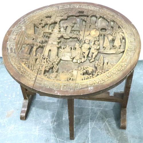 3105 - An early 20th century Chinese camphor carved table with circular top and folding frame, D: 60 cm, H:... 