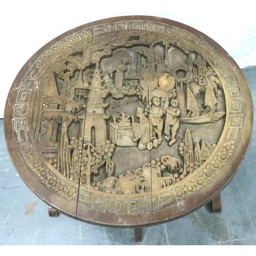 3105 - An early 20th century Chinese camphor carved table with circular top and folding frame, D: 60 cm, H:... 