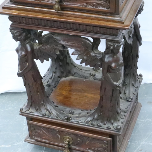 3106 - An unusual 19th century heavily carved two drawer lamp table, with supports in the form of four ange... 