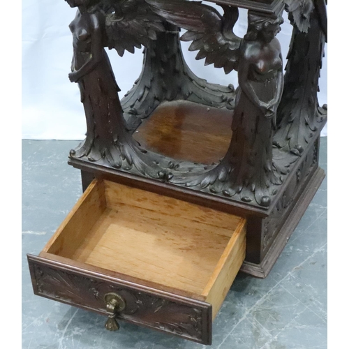 3106 - An unusual 19th century heavily carved two drawer lamp table, with supports in the form of four ange... 