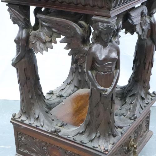 3106 - An unusual 19th century heavily carved two drawer lamp table, with supports in the form of four ange... 