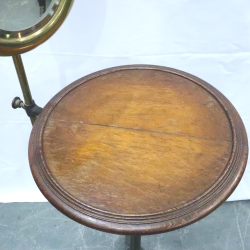 3117 - An Edwardian gentlemans wash stand, having an adjustable brass shaving mirror, circular oak stand an... 