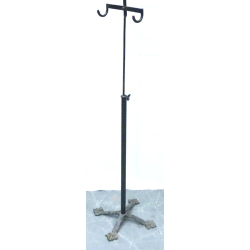 3118 - An Edwardian gentlemans height adjusting apparel stand with two hooks, raised on a cast iron support... 