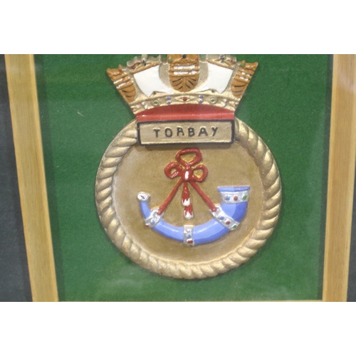 2113 - Large framed montage from the launching of HMS Torbay including plaque, badge and champagne top with... 