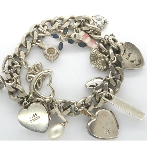 38 - Silver charm bracelet with fifteen charms, combined 53g. P&P Group 1 (£14+VAT for the first lot and ... 