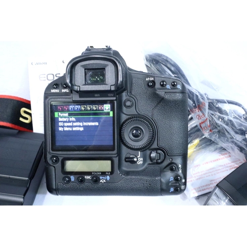 409 - Boxed Canon EOS 1D mark IV digital camera with charger, leads, strap and instruction manual, and a C... 