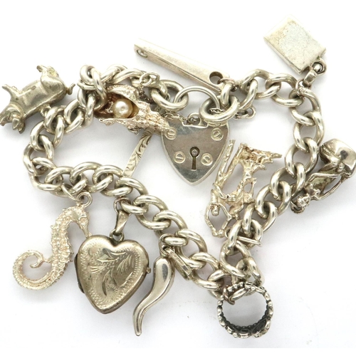 50 - Silver charm bracelet with eleven charms, combined 43g. P&P Group 1 (£14+VAT for the first lot and £... 