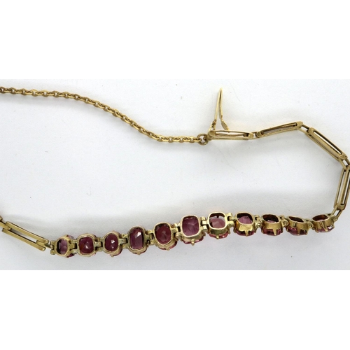 86 - Presumed gold (unmarked) delicate bracelet set with eleven graduated amethyst stones, with guard cha... 