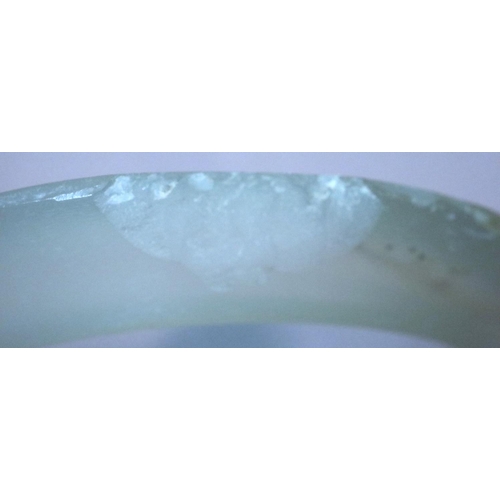 320 - Carved Chinese jade bangle, chips to rim. Internal D: 48 mm, external D: 67 mm. P&P Group 1 (£14+VAT... 