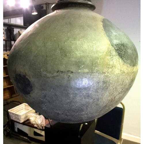 3048 - A large 18th century stoneware egg fermenting chamber, raised on museum plinth with later bronze cov... 