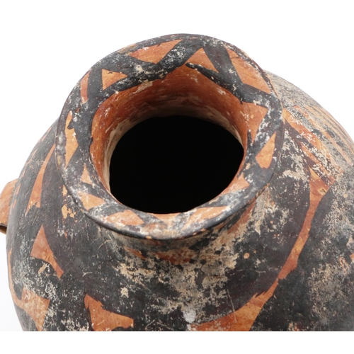 3001 - A Neolithic period terracotta vessel, with flared tubular neck and two loop handles; the upper body ... 