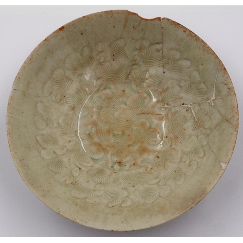 3003 - A celadon glazed porcelain bowl having incised decoration to its interior and a footed base, D: 17 c... 