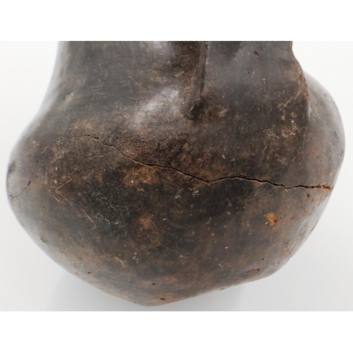 3005 - A Han Dynasty black pottery amphora vessel, the body stylised with twin handles, H: 13 cm. Crack to ... 