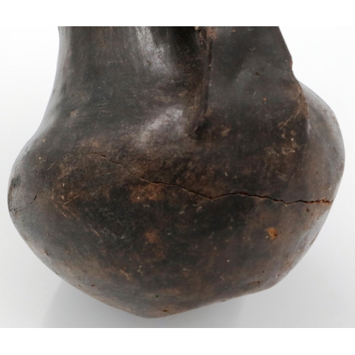 3005 - A Han Dynasty black pottery amphora vessel, the body stylised with twin handles, H: 13 cm. Crack to ... 