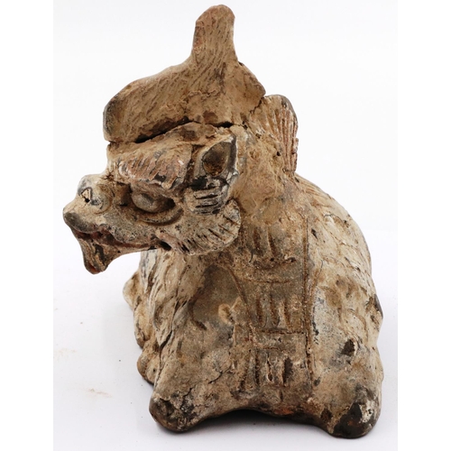 3007 - A Ming Dynasty zoomorphic clay recumbent dragon ornament, still showing signs of polychrome decorati... 