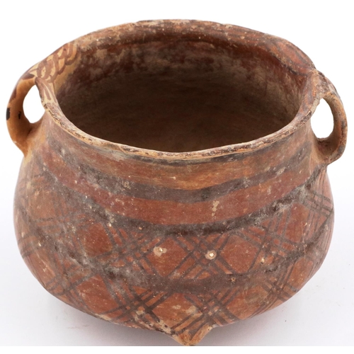 3009 - A Neolithic period terracotta pot, with flared rim and two loop handles; the upper body painted with... 