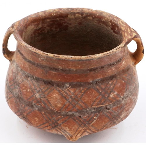 3009 - A Neolithic period terracotta pot, with flared rim and two loop handles; the upper body painted with... 