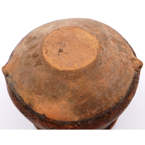 3009 - A Neolithic period terracotta pot, with flared rim and two loop handles; the upper body painted with... 