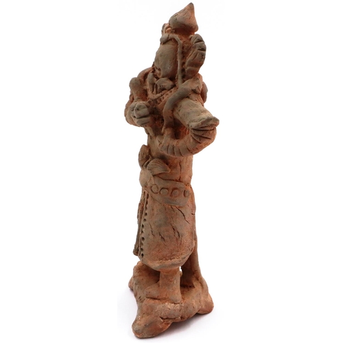 3021 - A Jian period terracotta figure of a Dragon God, possibly Sihai Longwang, standing atop a terrace, r... 