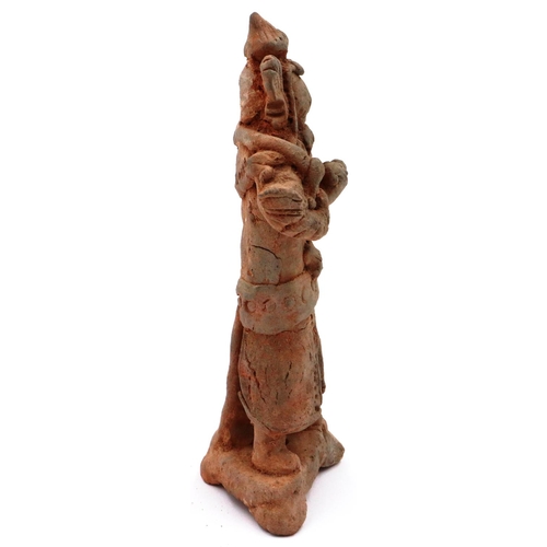 3021 - A Jian period terracotta figure of a Dragon God, possibly Sihai Longwang, standing atop a terrace, r... 